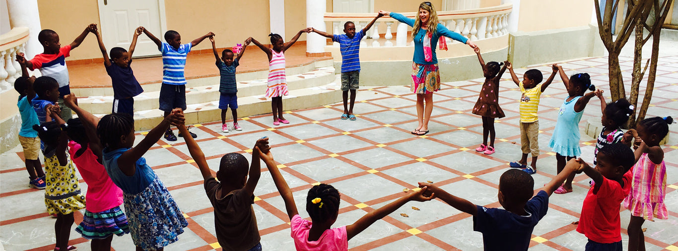 Founder Lisa with kids from Jacmel Children's Center, Giving Back