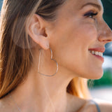 Silver Heart Hoops, shown on model